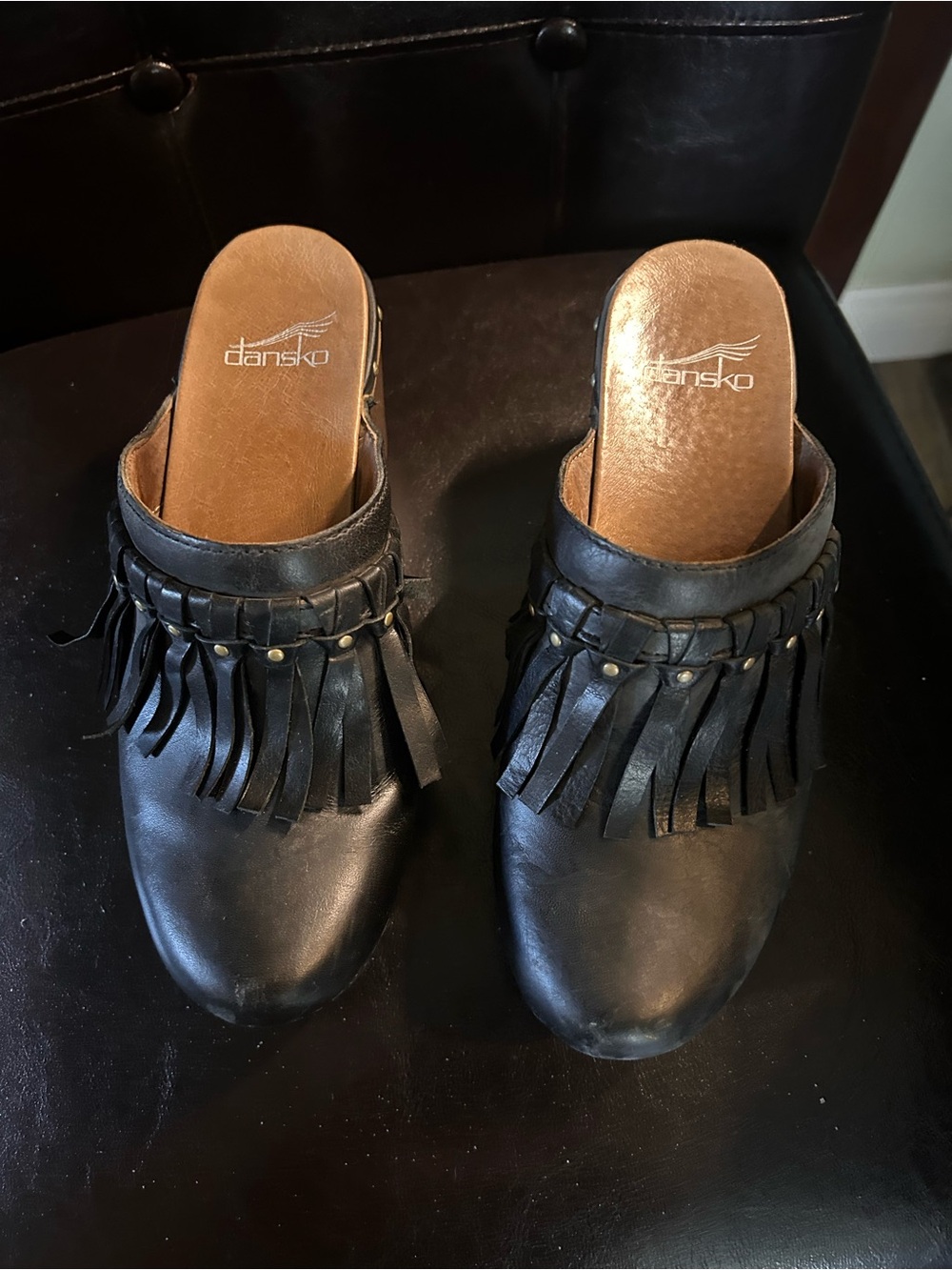 Dansko Black Leather Fringe Clogs